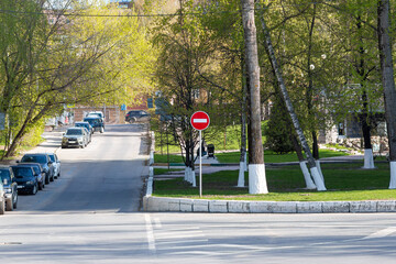 One-way street view. Sign brick entry is forbidden near the park