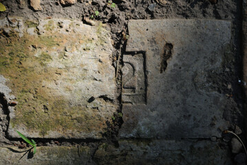 The inscription symbol 2 on the halve old brick. Vintage, close up, frame