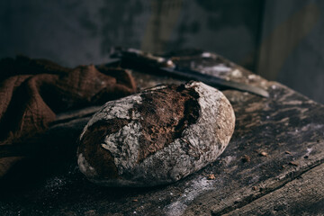 Delicious fresh bread on table in kitchen