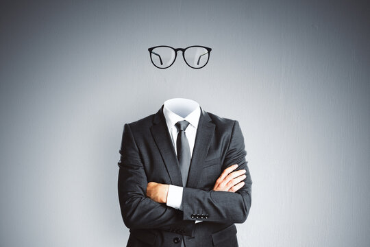 Headless invisible businessman in suit with folded arms and abstract glasses standing on gray wall background. Business and secret concept.