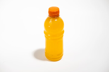 Bottle of fresh orange drink on white background