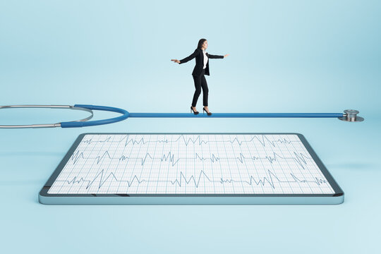 Attractive Young European Businesswoman Balancing On Stethoscope Above Tablet With Cardiology Screen On Light Background. Medicine And Doctor, Healthcare Concept.