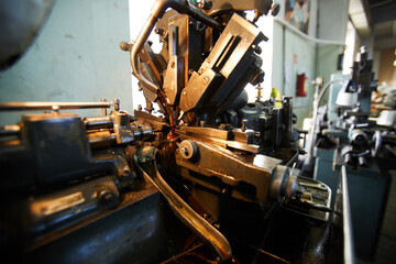 Close-up of lathe milling machine with copper parts joining together and dark copper liquid running...