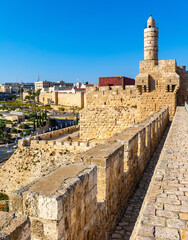 Ottoman minaret above walls and archeological excavation site of Tower Of David citadel stronghold in Jerusalem Old City in Israel