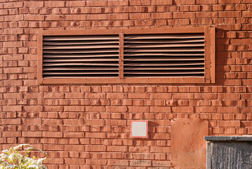 Wide lattice on the brick wall of the house