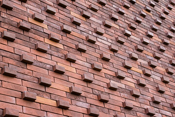 Wall pattern made of red bricks in different shades
