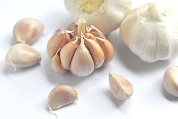 garlic bulbs and garlic cloves on white background. close-up. Organic garlic top view. Concept of spices for healthy cooking.