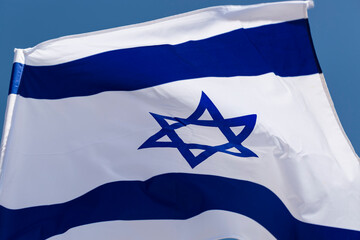 Close up of national Israeli flag develops in a wave in the wind. The concept of Israel...