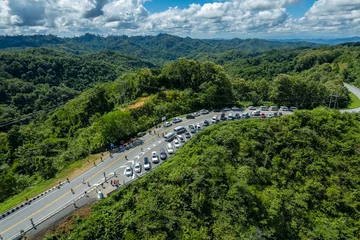 Fototapete Rund Naturpark Many cars have parked in the parking area at the zigzag road is similar to the number 3. This road is built on a mountain, past the forest in Nan, Thailand.  © Around Ball