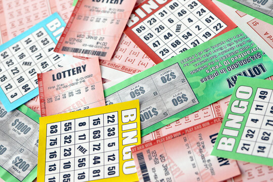 Many used lottery tickets, bills with numbers and bingo playing boards in big pile. Gambling and lottery paper stuff