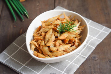 a plate of fried crispy fish on the table 