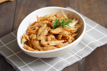 a plate of fried crispy fish on the table 