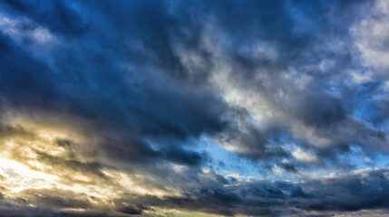 Naklejka na ściany i meble Dramatic evening sky with clouds at sunset