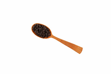 Black chickpeas in wooden spoon on white background, close-up. Design element, copy space. Black chickpeas, with their high fiber content, are very healthy to consume