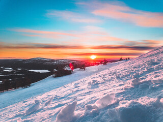 Santa's cottage in the hills of Levi ski resort in the Finnish Lapland at sunset.