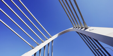 Element of modern bridge structure against clear blue sky. Architecture and construction concept.