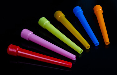 Colored plastic hookah mouth tips, standing in an isolated private environment, accessories on a...