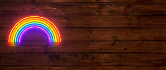 led neon rainbow hanging on the wooden wall