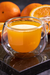 Freshly squeezed orange juice on a dark background. Fresh orange juice. close up