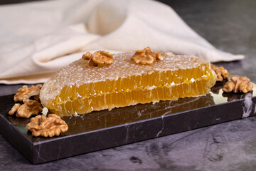 Honey. Honeycomb on dark background. Fresh organic honey comb on marble. close up