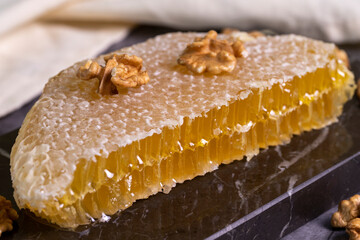 Honey. Honeycomb on dark background. Fresh organic honey comb on marble. close up