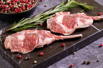 Lamb chops on dark background. Raw lamb chops with spices. close up