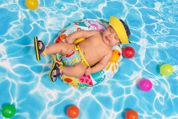 Studio portrait of a baby enjoying in a swimming pool.