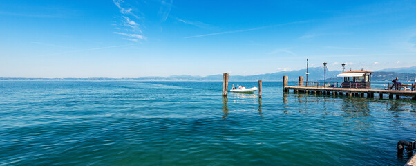 Lake Garda (Lago di Garda) with the pier used as a ferry terminal, small port of Lazise village,...