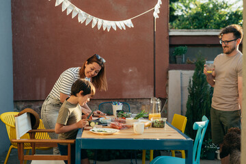 boy helps her mother preparing food for barbecue