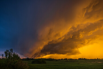 Obraz na płótnie Canvas Storm cloud in the sunset light, shelf cloud with dramatic light
