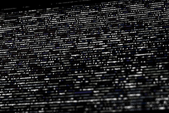 Black and white code background. compressed website javascript code