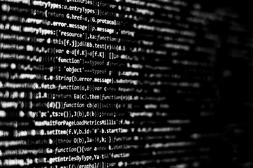 Black and white code background. javascript code on computer screen