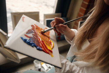 Female Artist Works on Abstract Oil Painting, Moving Paint Brush Energetically She Creates Modern...