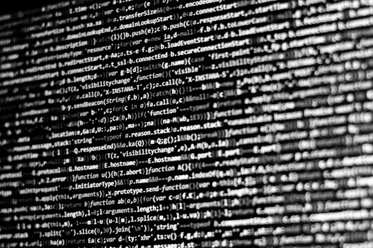 Black and white code background. javascript code on computer screen
