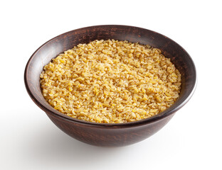 Uncooked bulgur in ceramic bowl isolated on white background with clipping path