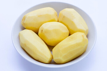 Raw peeled potatoes on white background