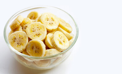 Banana slices in glass bowl on white