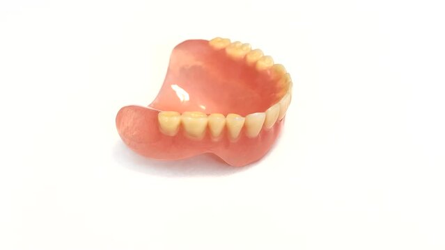 Rotation of the Upper Removable Jaw denture. Isolated on white.