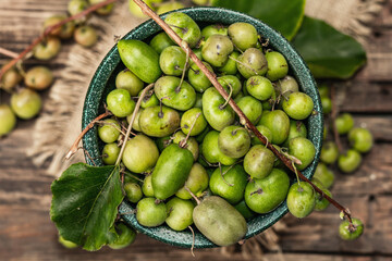 Harvest of ripe Actinidia arguta kiwi in a ceramic bowl