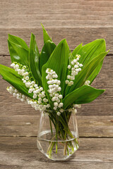 Lily valley flowers bouquet with green leaves. Nature object for the design of festive greeting card