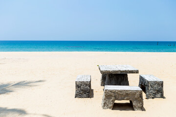 Stone bench set on tropical beach in south of Thailand, relaxing by the sea, summer outdoor day light