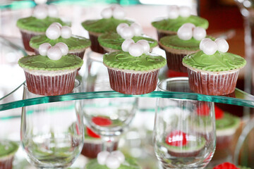 Delicious sweet cupcakes and pastry at wedding dessert table reception