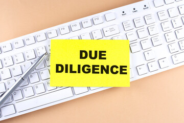 Text DUE DILIGENCE text on a sticky on keyboard, business concept