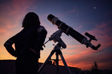 Girl with astronomical telescope stargazing under twilight sky.