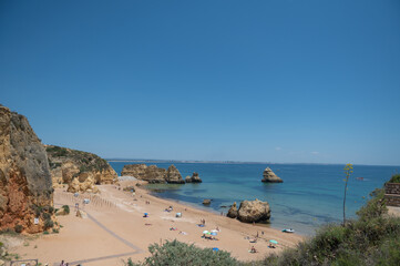 Obraz premium Panorama of the tourist Praia de Dona Ana de Lagos in the Algarve, Portugal in the summer of 2022.