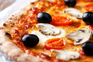 Pizza with back olives, mushrooms and fresh oregano.