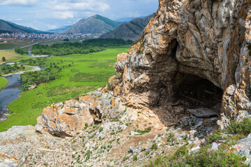 View from the cave in the mountain over the hills, mountains, valley, river and village. Ust-Kansk,...