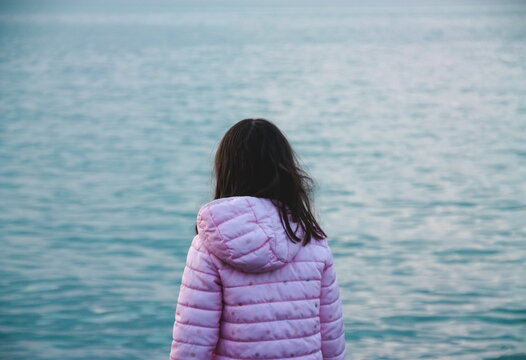 Little girl depressed at the beach
