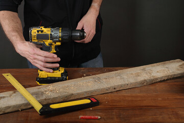 person grabs a power cordless screwdriver to work