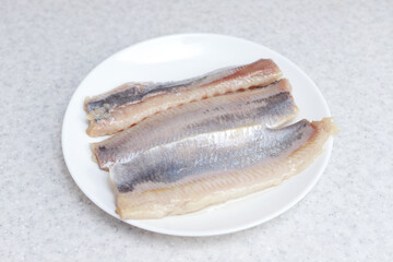herring fillets on a plate on the table